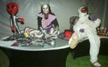 An Aramark worker at the Odyssey Ball staffs the "candy bar" with hologram candy and an astronaut mannequin.