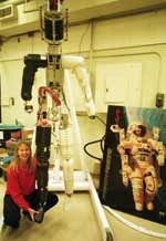 Professor Dava J. Newman shows the degree of mobility in the space suit she and colleagues designed and which they hope will be used in a future mission to Mars. Current space suits have feet that simply lock into place, but those in the next-generation suit will need to be able to move around more freely.