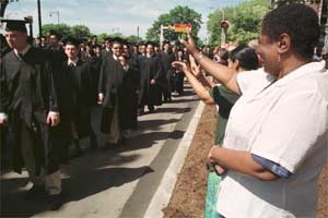 Graduates file toward Killian Court.