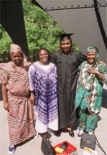Kirimania Murithi with his three mothers in front of the The Great Sail in McDermott Court. Left to right: Kanugu Mbaya, the midwife who delivered him; Faith Anampiu, who provided a home for him when he attended the Alliance School in Nairobi; and his birth mother, Elizabeth Njiru.