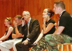 Participants in the "Survivor" spoof at convocation, from left, junior Trisha McAndrew, staff associate Dan Chapman, President Charles M. Vest, senior Roxanne Cartwright, and junior Michael Ramos.