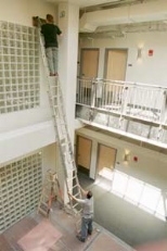 Workmen put some finishing touches on the inside of the new graduate residence at 224 Albany St.