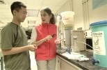 At MIT, Murcott and graduate student Jason Low of civil and environmental engineering survey microbial colonies in a dish from one of the water filtration techniques they are examining for potential use in Nepal.