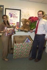 A toy drive sponsored by the Campus Police and the Parking and Transportation Office allowed people to donate toys in lieu of paying parking tickets. Hazeb Adugna (left) and Larry Brutti of Parking and Transportation look at some of the donated toys.