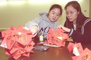 To prepare for the Chinese Students Club's annual Chinese New Year's banquet next month, Kathy Li '05, one of the co-coordinators of an IAP craft-making course, works with Yvonne Xiang, whose husband Hong Xiang is a postdoc associate at the Laboratory for Nuclear Science.