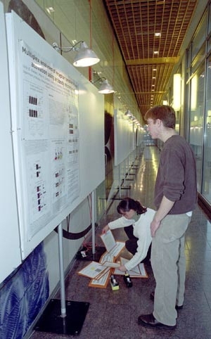 John Albeck, a graduate student in cellular biology, and Suzanne Gaudet,        a postdoctoral fellow in biology, prepared for the poster competition at        the symposium held in honor of MIT's new BioMicro Center (see MIT        Tech Talk, Jan. 9 ). The Jan. 11 symposium, "Computational and Systems Biology: From Biofabrication to Bioinformatics," was the first of what will become an annual eve...