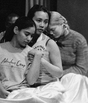 Sophomore Rosa Obregon of aeronautics and astronautics (left), junior Kim Nguyen of electrical engineering and computer science (center), and freshman Hillary Stanton portray immigrants trying to reach America in a boat lost at sea in a rehearsal for "Seachange."