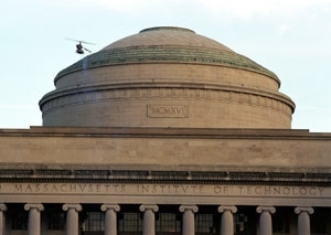 The five-foot robotic helicopter made by MIT engineers hovers beside the        dome during a test flight