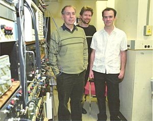Bertrand Delgutte (left) and Andrew Oxenham (center),  research scientists at MIT's Research Laboratory of Electronics, join HST graduate  student Zachary Smith in their lab.