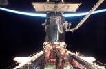 Michael Massimino working on the Hubble Space  Telescope from the end of Columbia's robotic arm. Massimino was the 10th  MIT graduate to perform an EVA (extravehicular activity).
