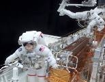 MIT alumnus John Grunsfeld (left) and Richard Linnehan work with the Hubble Space Telescope's new solar arrays in Columbia's open cargo bay        during an EVA on last week's mission to upgrade some of Hubble's        equipment.
