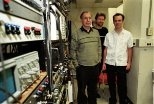 Bertrand Delgutte (left) and Andrew Oxenham (center), research scientists at the  Research Lab for Electronics, meet with graduate student Zachary Smith in the  lab.