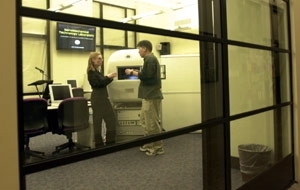 Glass walls and plasma screen displays inform  passersby in the Infinite Corridor of the activities of MIT's new NanoMechanical  Technology Laboratory in Building 8.