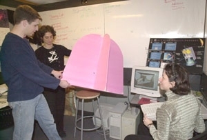 Paul Wooster (left), a senior in aero/astro, and graduate students Kalina        Galabova and Carole Joppin (far right) are building a prototype of a space capsule for launching mice into low-Earth orbit. The $5 million to $10 million project involves students interested in Mars travel at three universities.