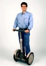Inventor Dean Kamen, who won the Lemelson-MIT Program's $500,000 prize this year, stands on his latest creation, the Segway Human Transporter.