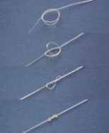 Photo above (Copyright Science magazine) shows how a fiber of the new biodegradable plastic with "memory" can  be used to tie a smart suture. After forming a loose knot, the ends of the suture  were fixed. The series shows from top to bottom how the knot tightened in 20 seconds  when heated to 40 degrees C.