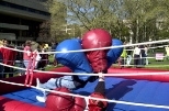 Giant soft boxing gloves appear to defeat the people using them at the Panhellenic Carnival on Kresge Oval Saturday.