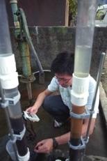 MIT student Tommy Ngai gathers results from the filtration unit he made to remove arsenic from well water in Parasi.