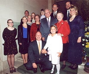 Professor Paul E. Gray and Priscilla K. Gray,  surrounded by their children and grandchildren at a ceremony renaming the President's  House to Gray House.