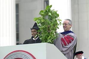 Sudeb Dalai, president of the Class of 2002, presents  a houseplant to President Vest that one of his classmates "hacked" several  years earlier from his office.