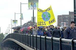 Marchers protesting World Bank policies cross  the Massachusetts Avenue bridge.