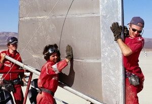 Thomas Massie, Rhett Creighton and Rony Kubat of the Geeks work on their "sand yacht" in a "Junkyard Wars" episode to be broadcast tonight and on June 16. They are vying against another MIT team, a group of alumnae dubbed the Quantum Mechanics.