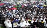 A very colorful, if very wet, crowd of families and other well-wishers sat        through a soggy Commencement.