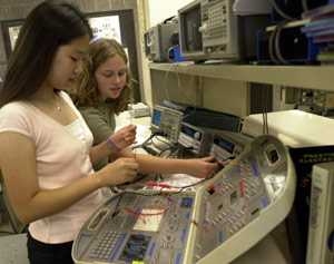High-school students Kyung Chang of Cairo (left) and Elena Glassman of Pennsylvania work with a circuit board during their electrical engineering class in the Women's Technology Program at MIT.