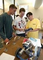 Left to right: Julien Barrier of France, MIT's Martin Jonikas of the United States and Alexandre Takeshi Ushima of Brazil collaborate on building a robot from scratch using a tablet PC as part of the International Design Contest. Although Jonikas won the 2.007 contest, he isn't allowed to reuse his design.