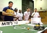 Teaching assistant Guillermo Chicas (far left) watches the winning robot        in action during the 2002 MITE2S robotics design competition. Team members who designed and built it were (left to right) Cherelle Walls, Oyinade Aderibigbe, Aaron Arizpe and Daniel Chaparro.