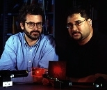Professor Neil Gershenfeld (left) and alumnus Ravi Pappu with an epoxy token made of tiny glass spheres that may improve digital information security on the Internet and elsewhere.