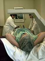 This machine to measure bone density is one of a number of technologies that MIT's General Clinical Research Center has to offer medical investigators. Lining up the patient and making her comfortable are Connie Pinto (left) and Ilene Horvitz.