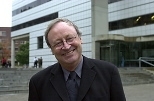 William J. Mitchell poses in front of the Media Laboratory.