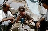 MIT's Charles Harvey (center) tastes molasses prior to its injection deep into a Bangladesh aquifer.