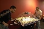 Dave Milanes (left), a graduate student in aeronautics and astronautics, and Dan Kirk, a postdoctoral associate in aero/astro, get into a game of table hockey in the new game room in the Stratton Student Center.
