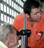 Media Lab graduate student Saul Griffith determines an elderly man's optometric  prescription during a trip to Guyana with the Midland (Texas) Lion's Club  to distribute donated eyeglasses.
