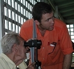 Media Lab graduate student Saul Griffith determines an elderly man's optometric prescription during a trip to Guyana with the Midland (Texas) Lions Club.
