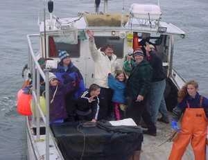 Mattie Thomson (center, in white jacket), skipper of the F/V Striker, took school children out on his fishing boat to teach them about marine ecology and a fisherman's life, as part of Adopt-a-Boat, a program coordinated by MIT Sea Grant.