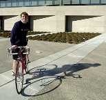Cancer survivor Kyle Rattray stands next to his bike outside the Zesiger Center. He and a friend will be riding their bikes from Boston to Seattle this summer to raise money for the American Cancer Society.