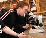 Mark Garagliano of Hudson High School checks out a specimen under the microscope
