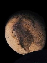 Pluto obstructed by its moon, Charon (lower right).