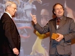 John V. Guttag, left, head of the Department of Electrical Engineering and Computer Science, plays "Robot John" for AI Lab director Rodney Brooks to illustrate how a robot learns tasks.