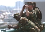 Three members of the National Guard keep a lookout for suspicious activity during Boston's Fourth of July celebration.