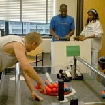 Students (from left) Wojciech Chrobak, Yaw Este and Krystle Shoate prepare for the robotic competition, the traditional culmination of MITE2S' six-week session.