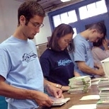 Freshman Chad Lieberman, sophomore Somin Lee and senior Douglas Quattrochi assemble more books.