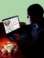 Assistant Professor Martin Culpepper with the HexFlex Nanomanipulator (foreground), which won a 2003 R&amp;D 100 Award.