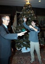 Freshman Benjamin Lu gives President Vest a lesson in contact juggling at Monday's holiday celebration in Gray House.