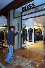Bass enters the Hugo Boss shop to begin his makeover.