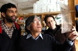 Graduate student Arvind Govindarajan (left), Professor Susumu Tonegawa (center) and postdoctoral fellow Ray Kelleher look at films in the lab.