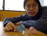 Sophomore Kathy Lin shows a pair of origami elephants she made.